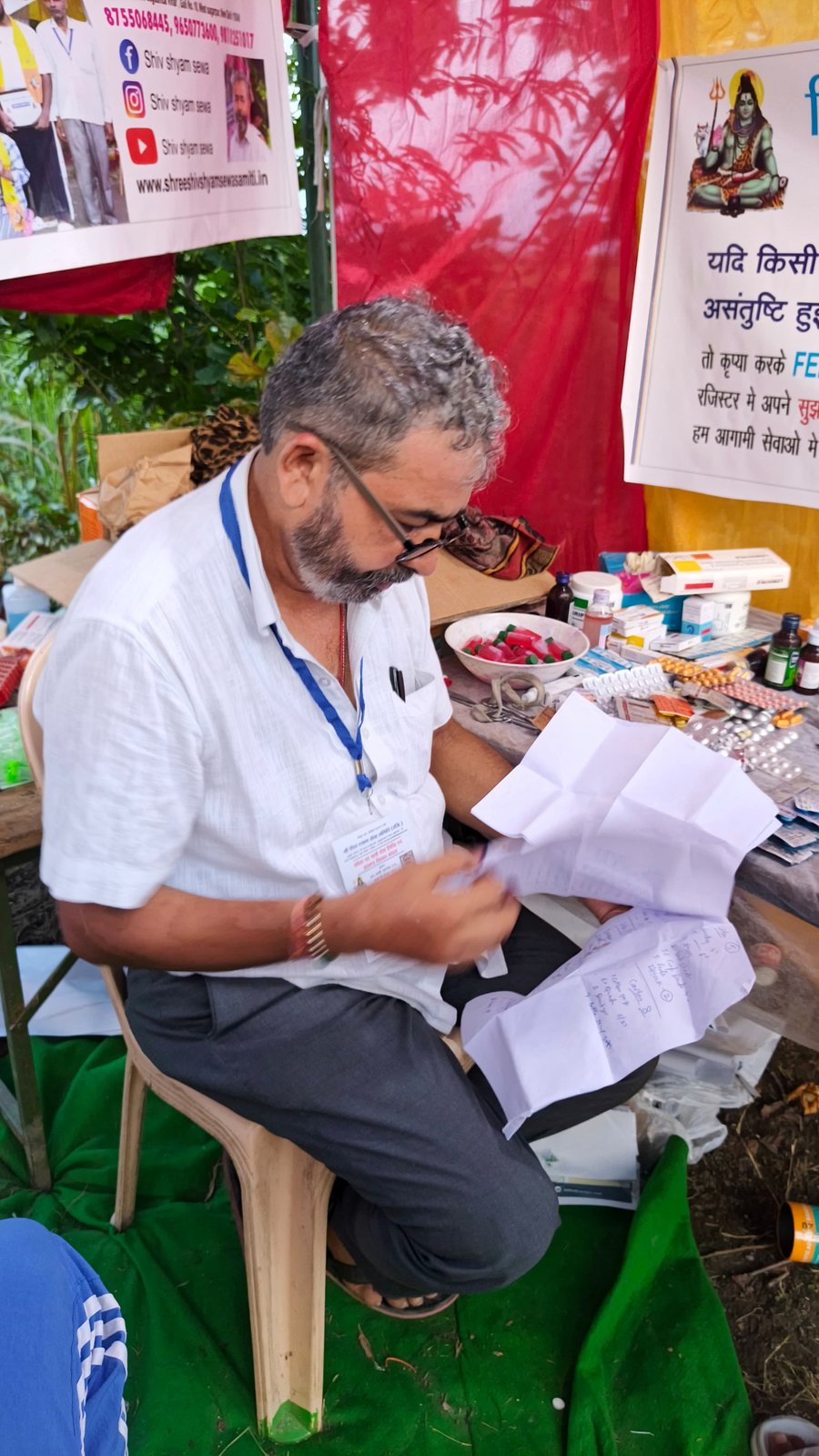 Doctor reviewing a patient's prescription at the free medicine table